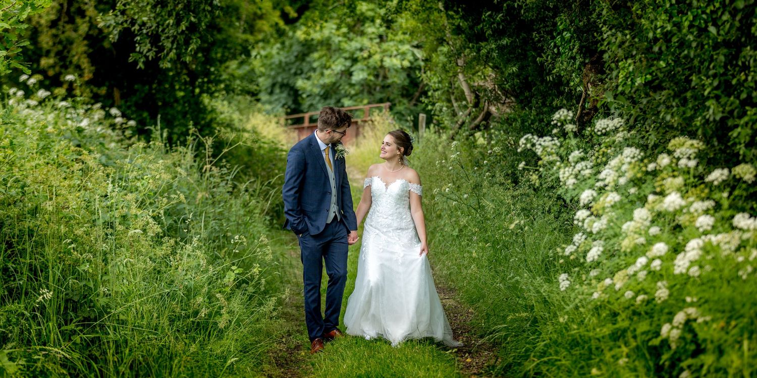 Natural garden pathway with white wildflowers creating a romantic wedding backdrop.