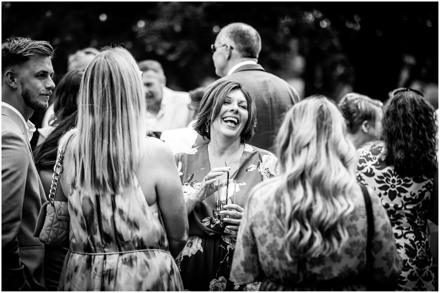 Black and white photos show natural candid moments between guests at a wedding reception.