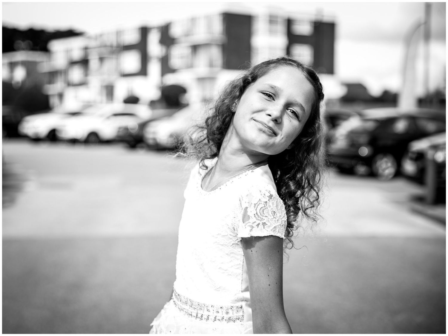Black and white panoramic sequence showing a child in white dress playing outdoors.