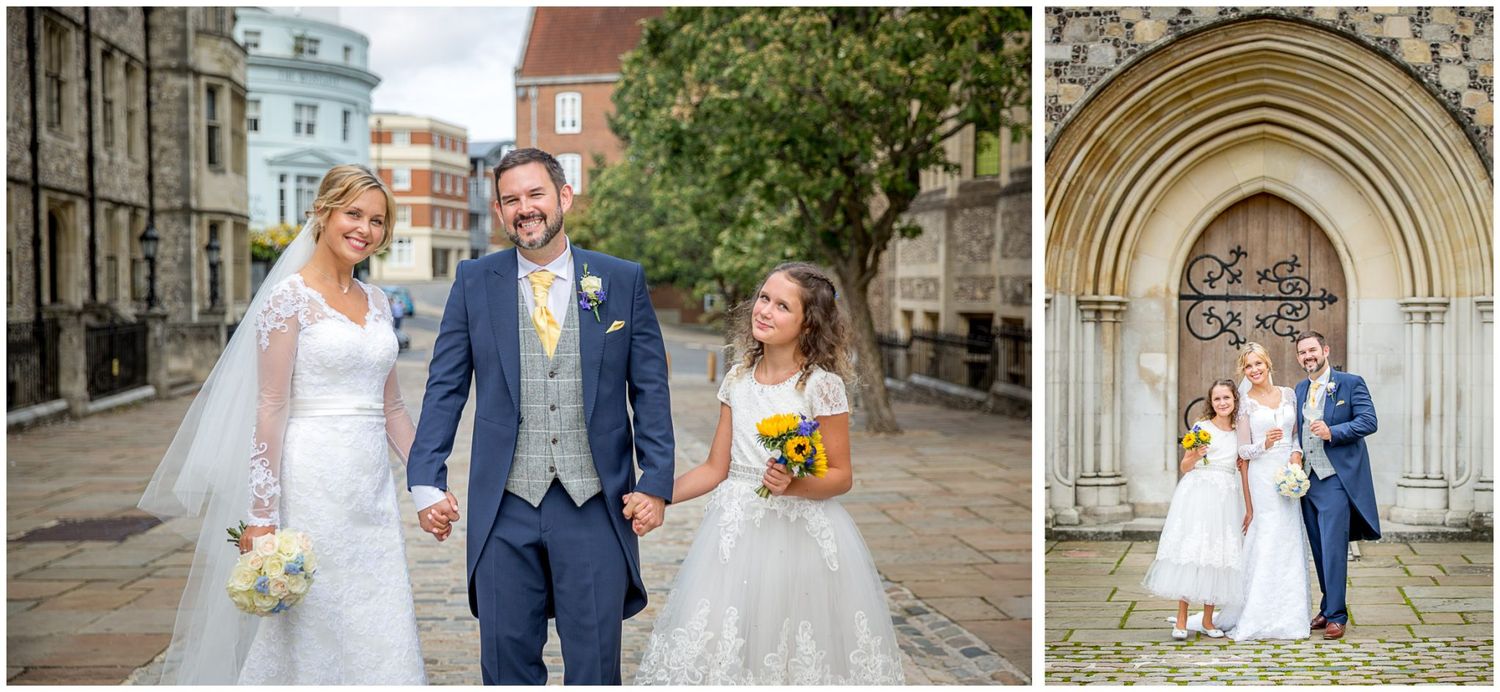 A couple shares a joyful moment together on their wedding day in front of a historic church entrance.