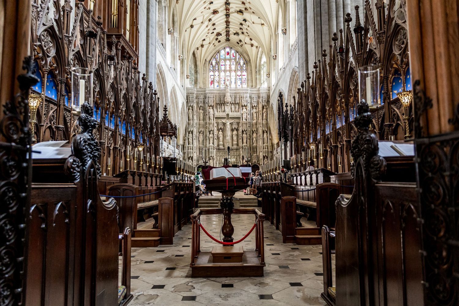 Interior view of a majestic cathedral with Gothic arches and intricate stone carvings.