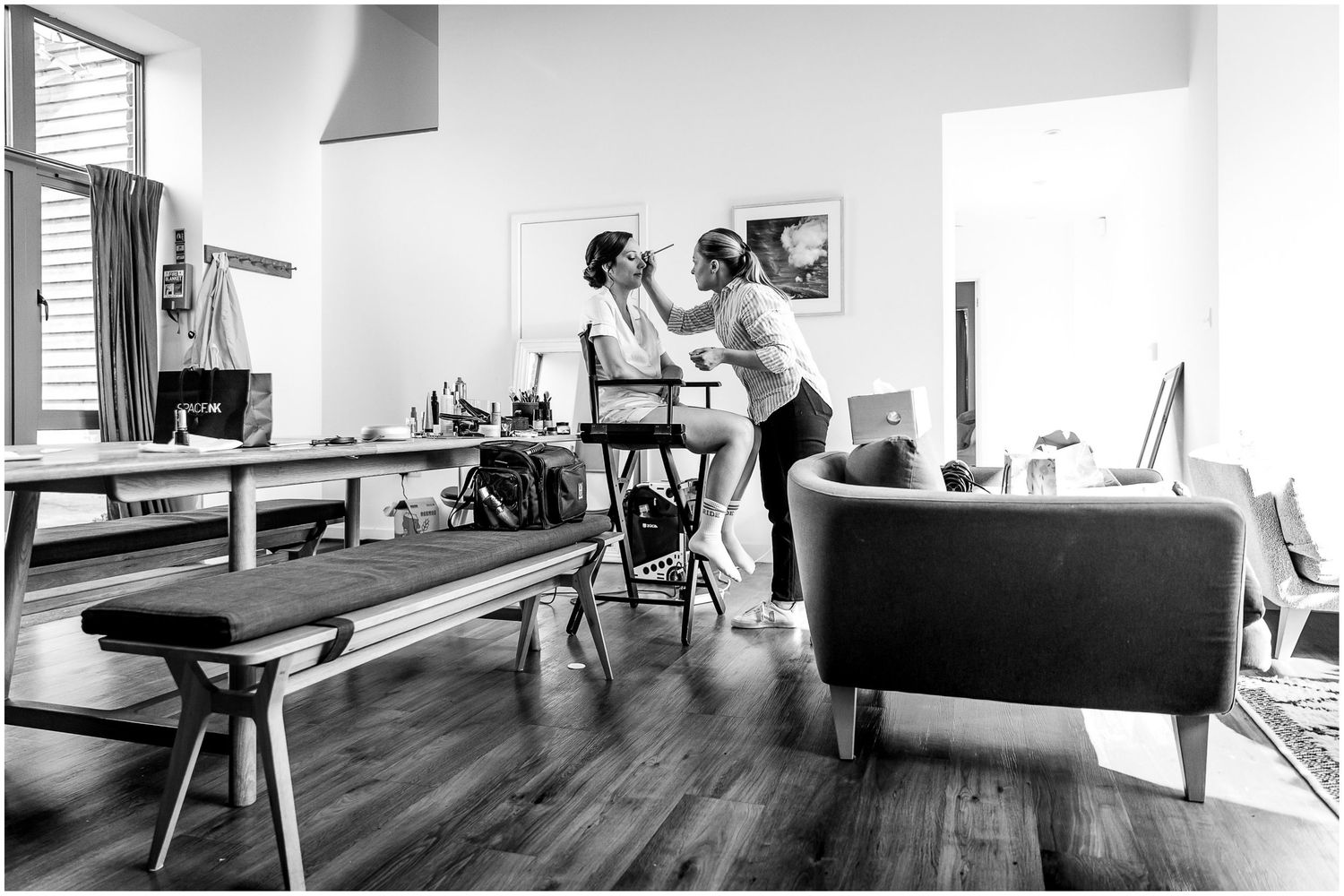 Series of black and white photographs showing people in conversation across a modern living space.