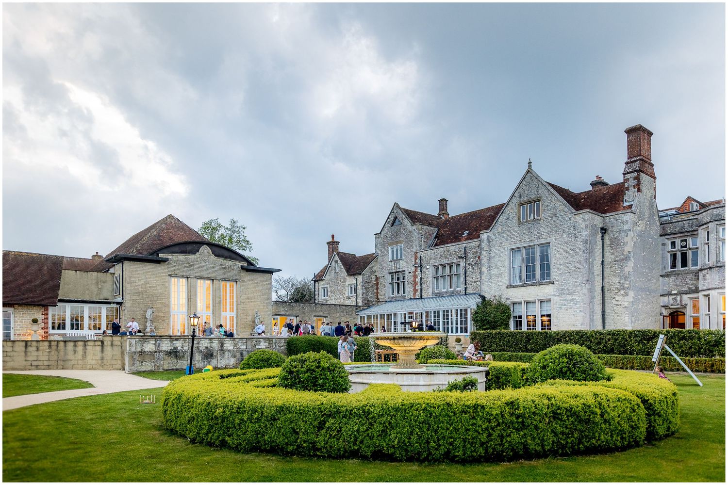 Panoramic view of elegant country estate wedding venue with manicured lawns.