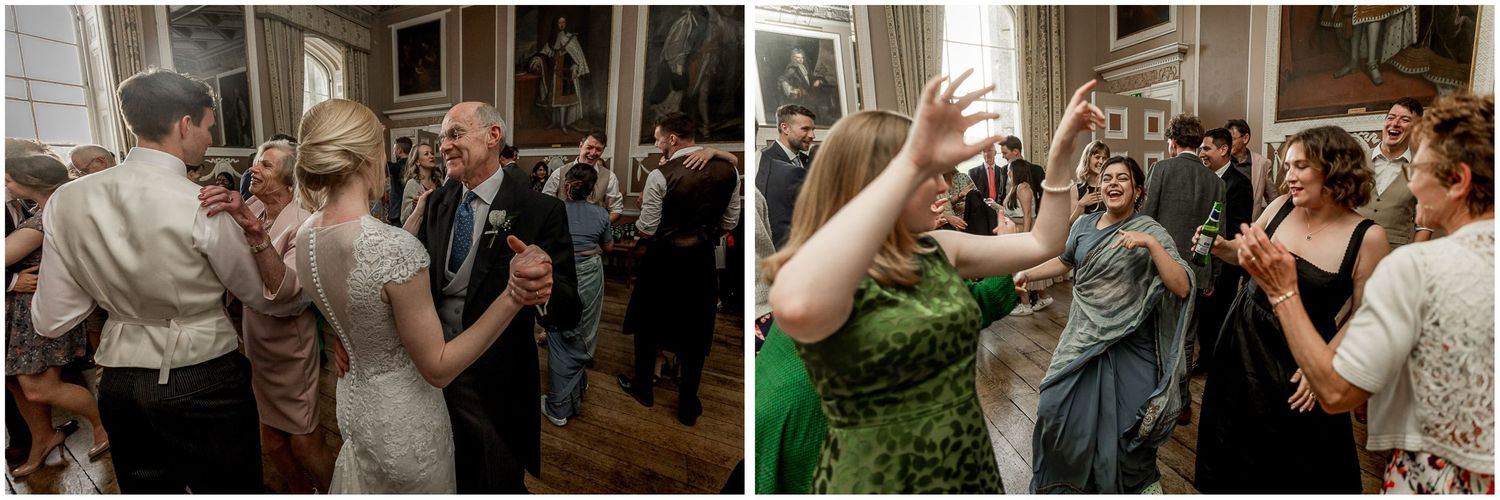 Wedding guests dancing and celebrating joyfully at a reception party.