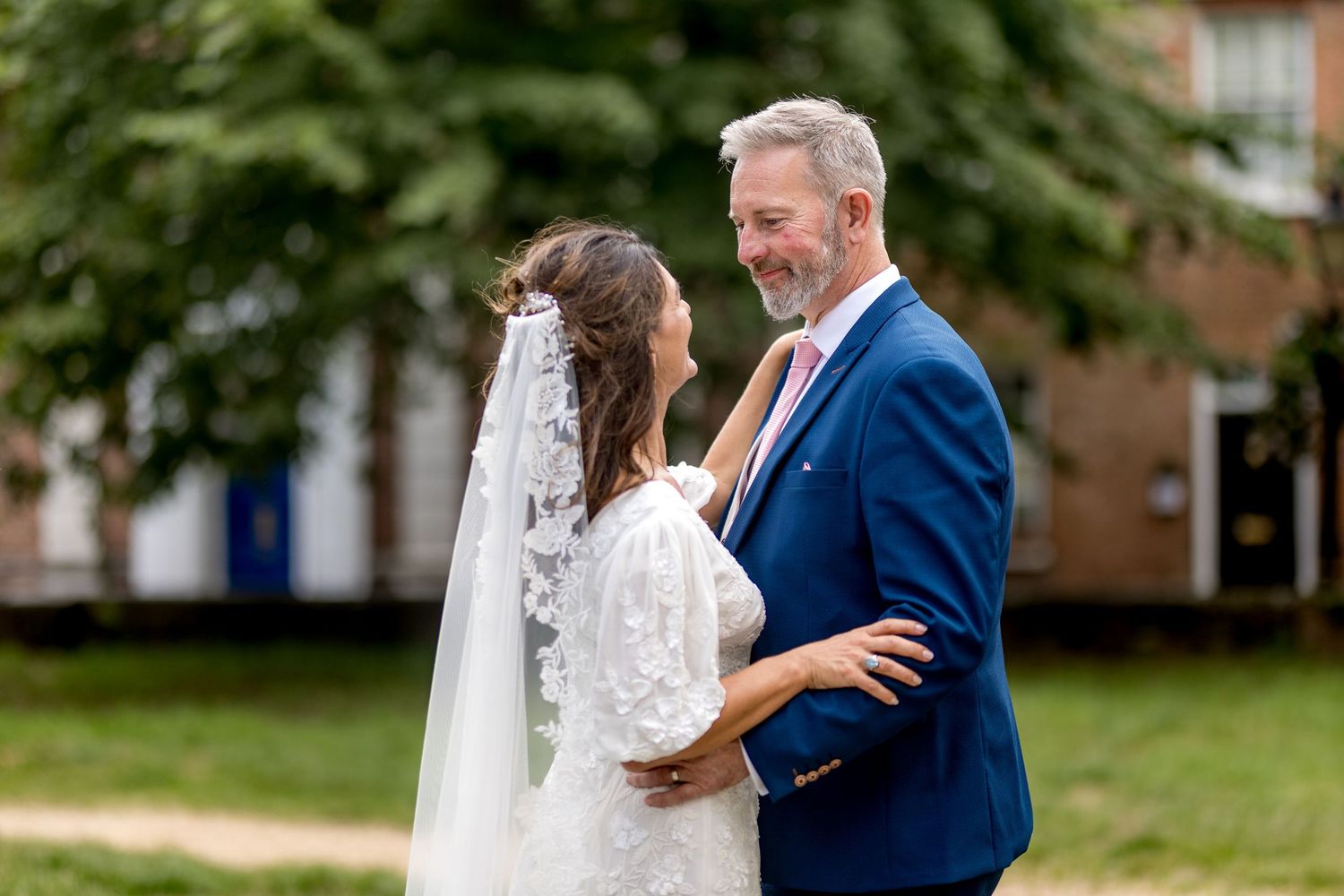 A romantic wedding photoshoot in a lush green garden setting.