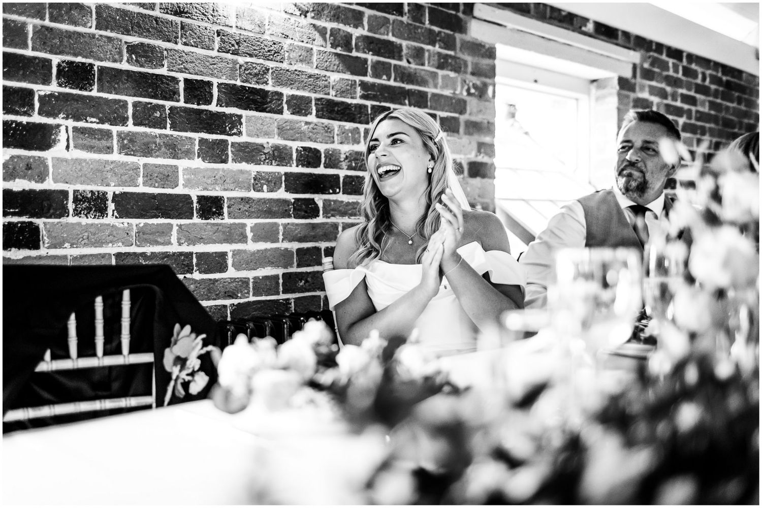 Black and white photos of wedding reception toasts and celebrations against brick wall background.