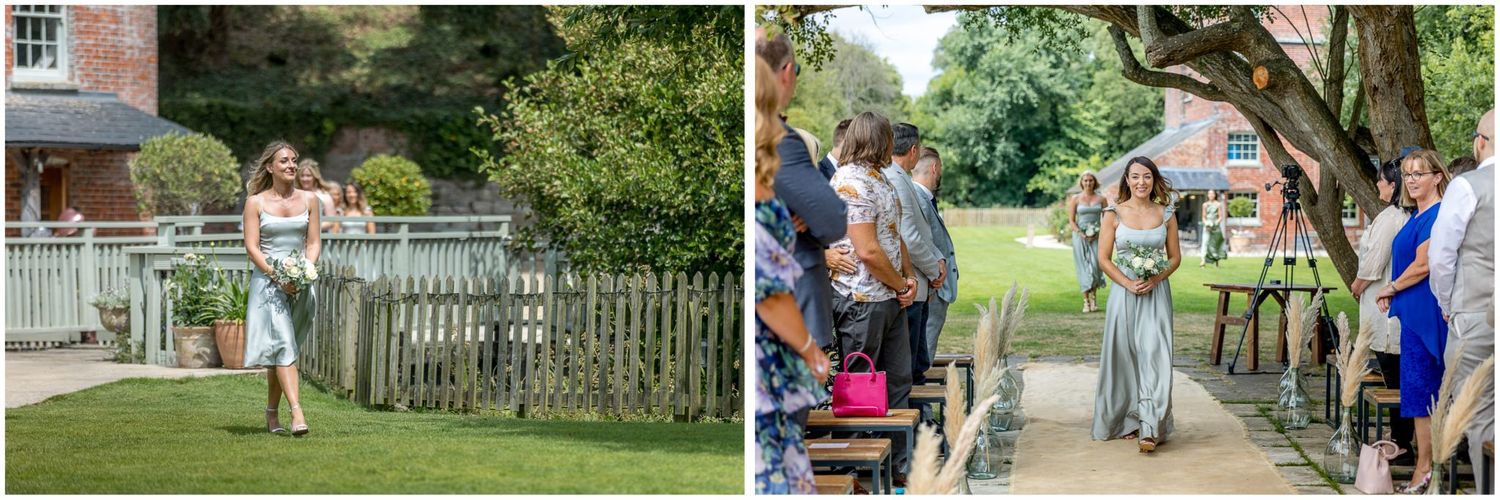 Wedding guests gather on garden paths and lawns during outdoor celebration.