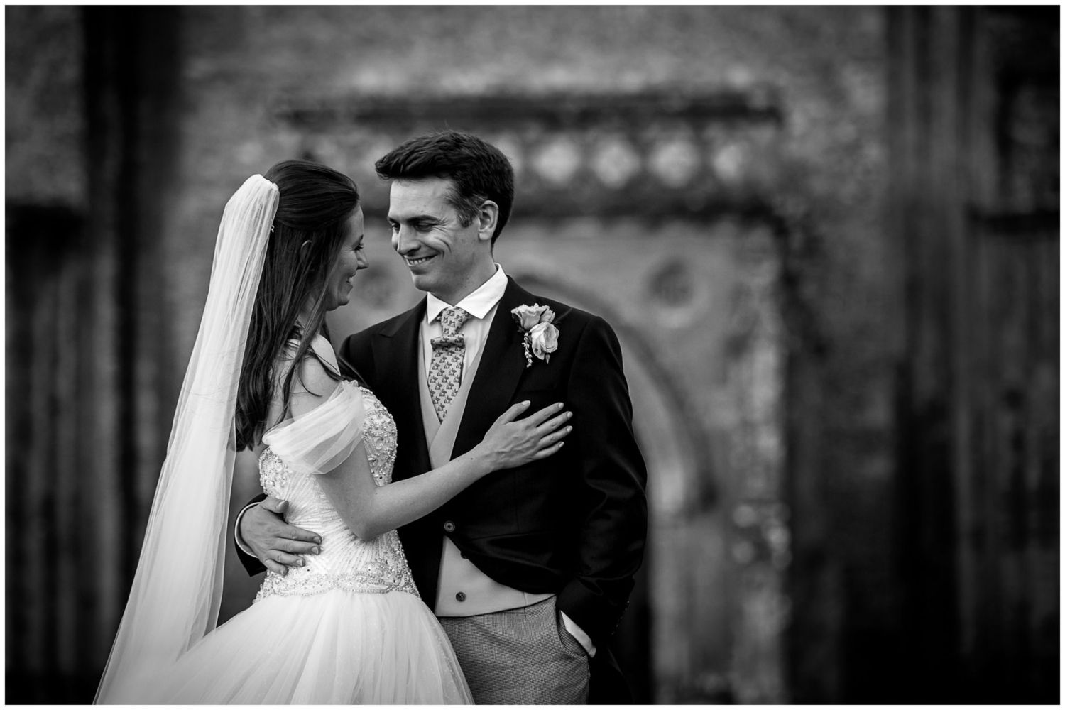 A series of black and white romantic wedding photos showing tender moments between newlyweds during their celebration.