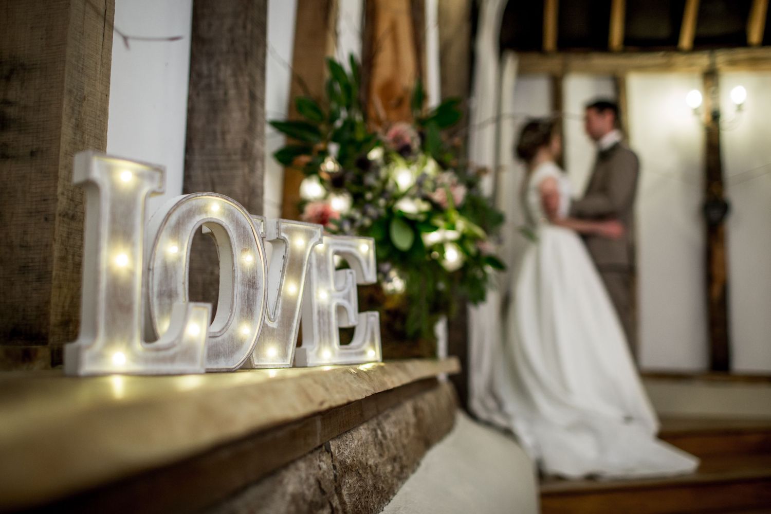 A wedding portrait in one of the smaller side rooms at Clock Barn in Hampshire with a focus on decorative details