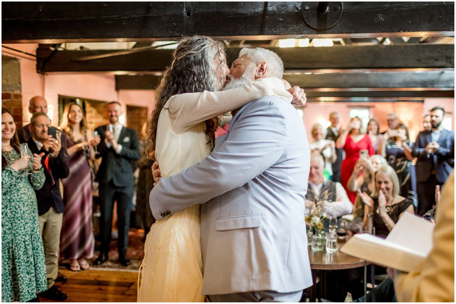 The wedding couple seal their marriage at Winchester's Abbey Mill with a kiss.