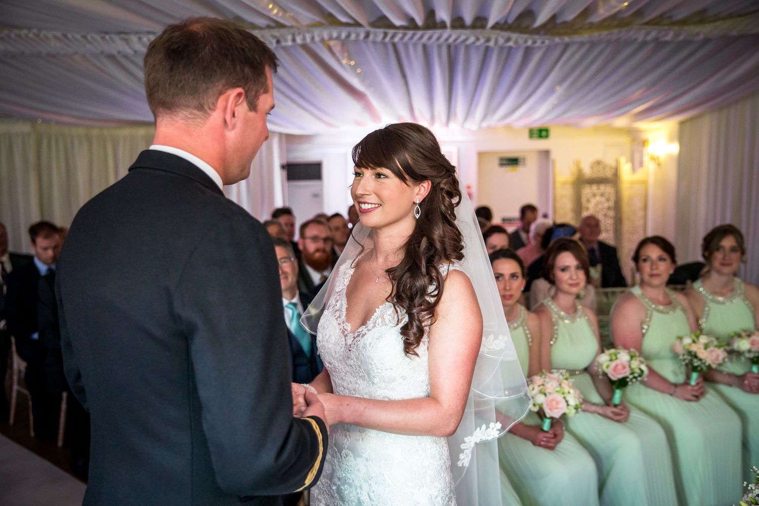 Southdowns Manor wedding photographer - indoor ceremony photograph of bride and groom making their vows