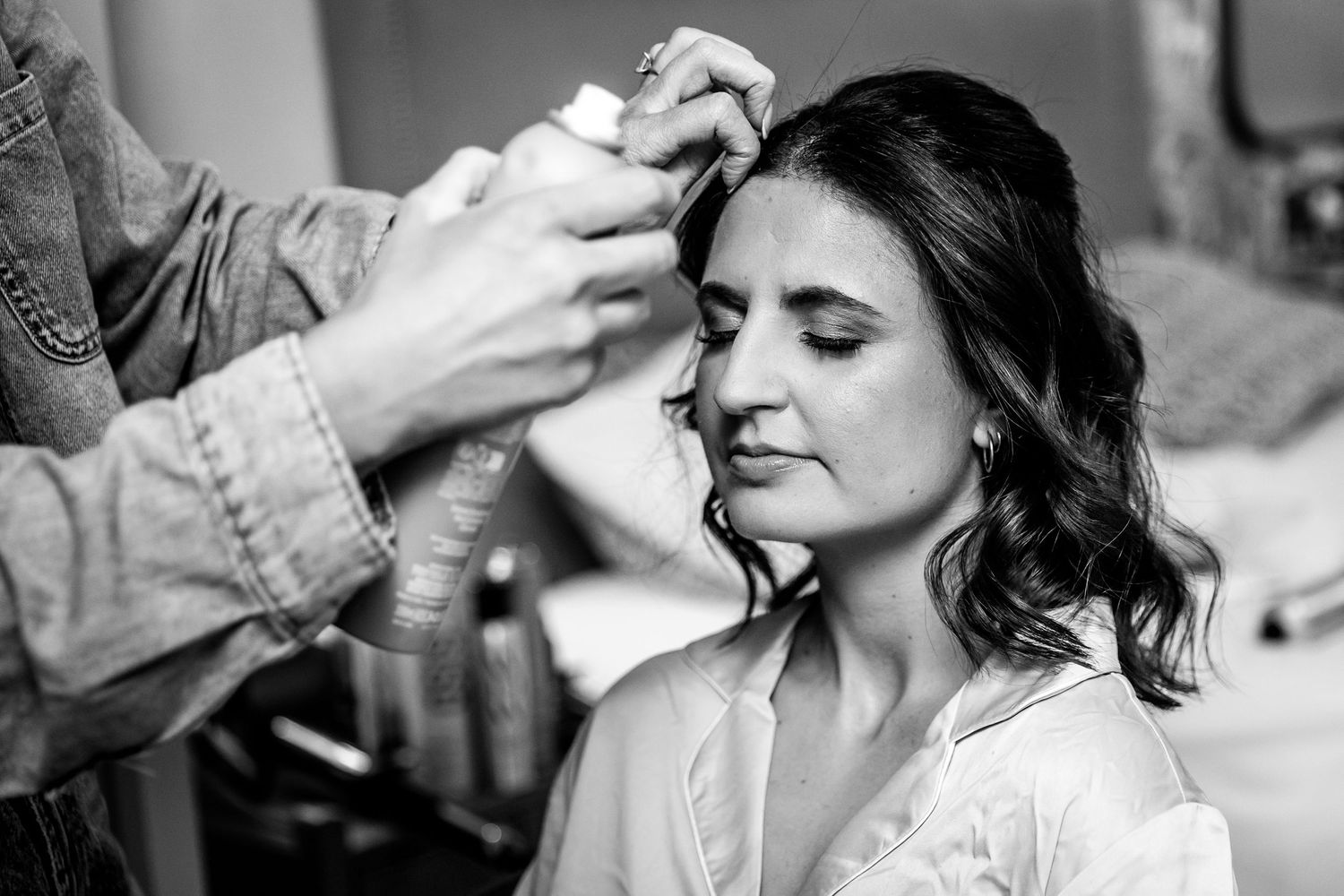 Black and white images of makeup application during bridal preparations.