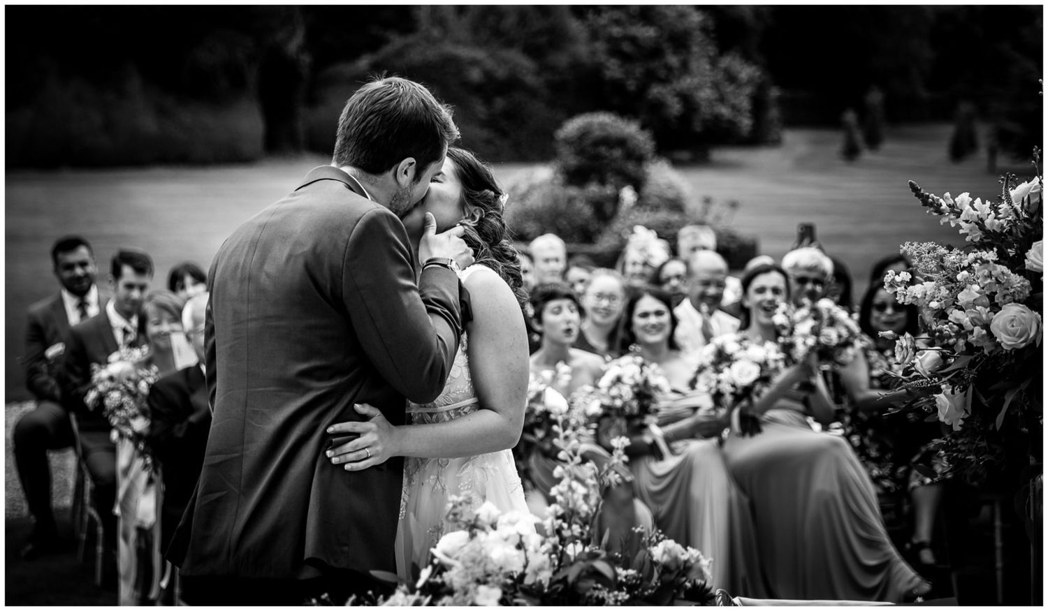Wedding ceremony attendees gathered on a beautiful summer day.
