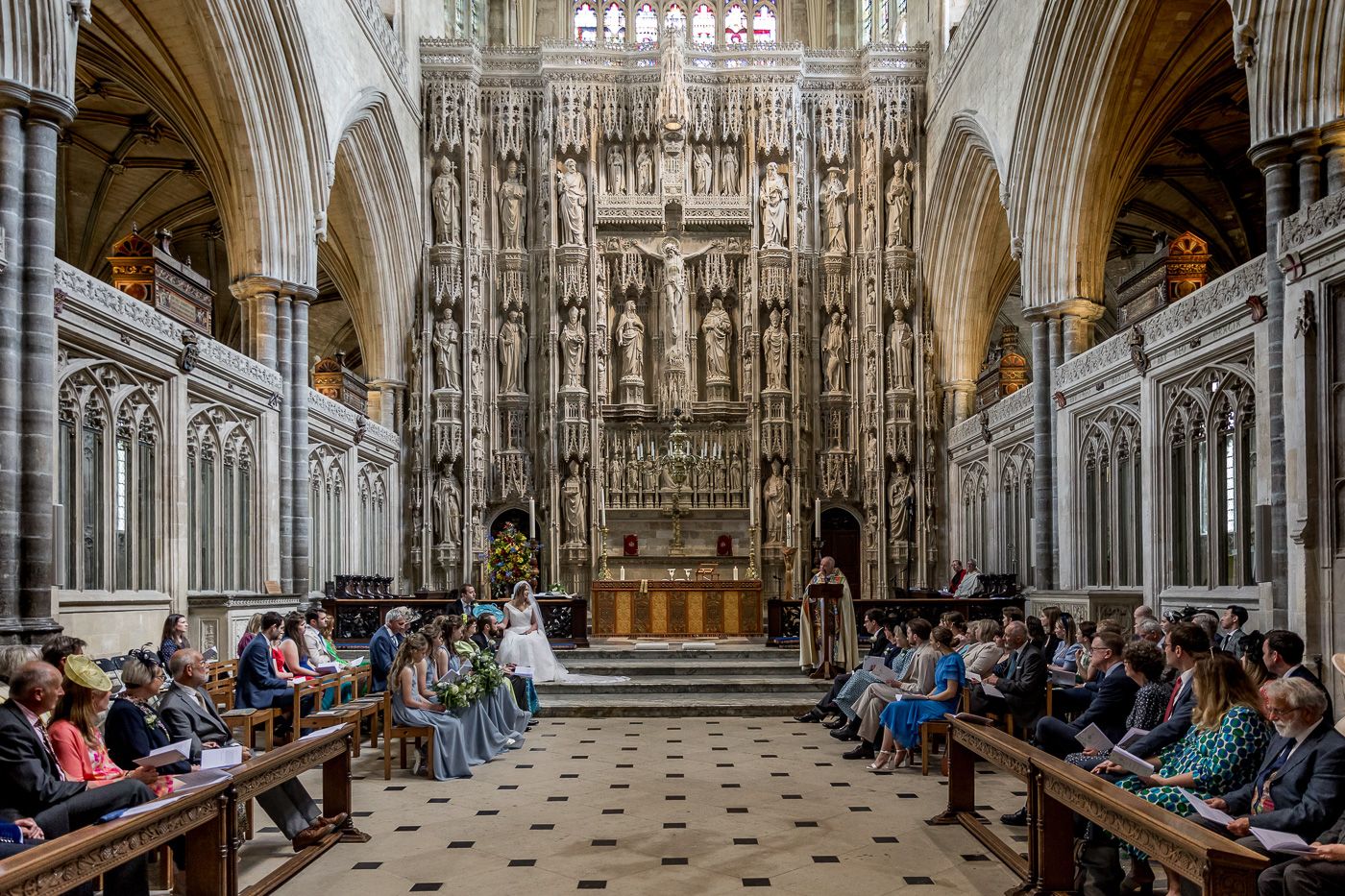 Majestic church interior with detailed Gothic architecture and rows of wooden pews.
