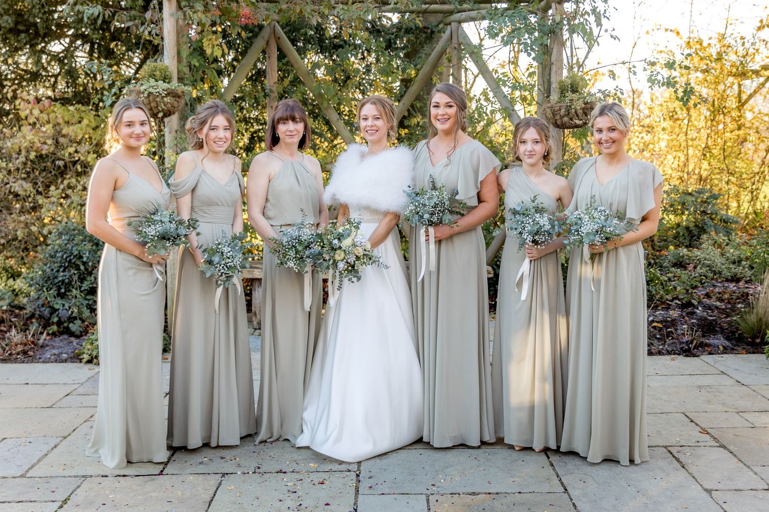Bridal party group portrait on the terrace at Clock Barn wedding venue near Winchester