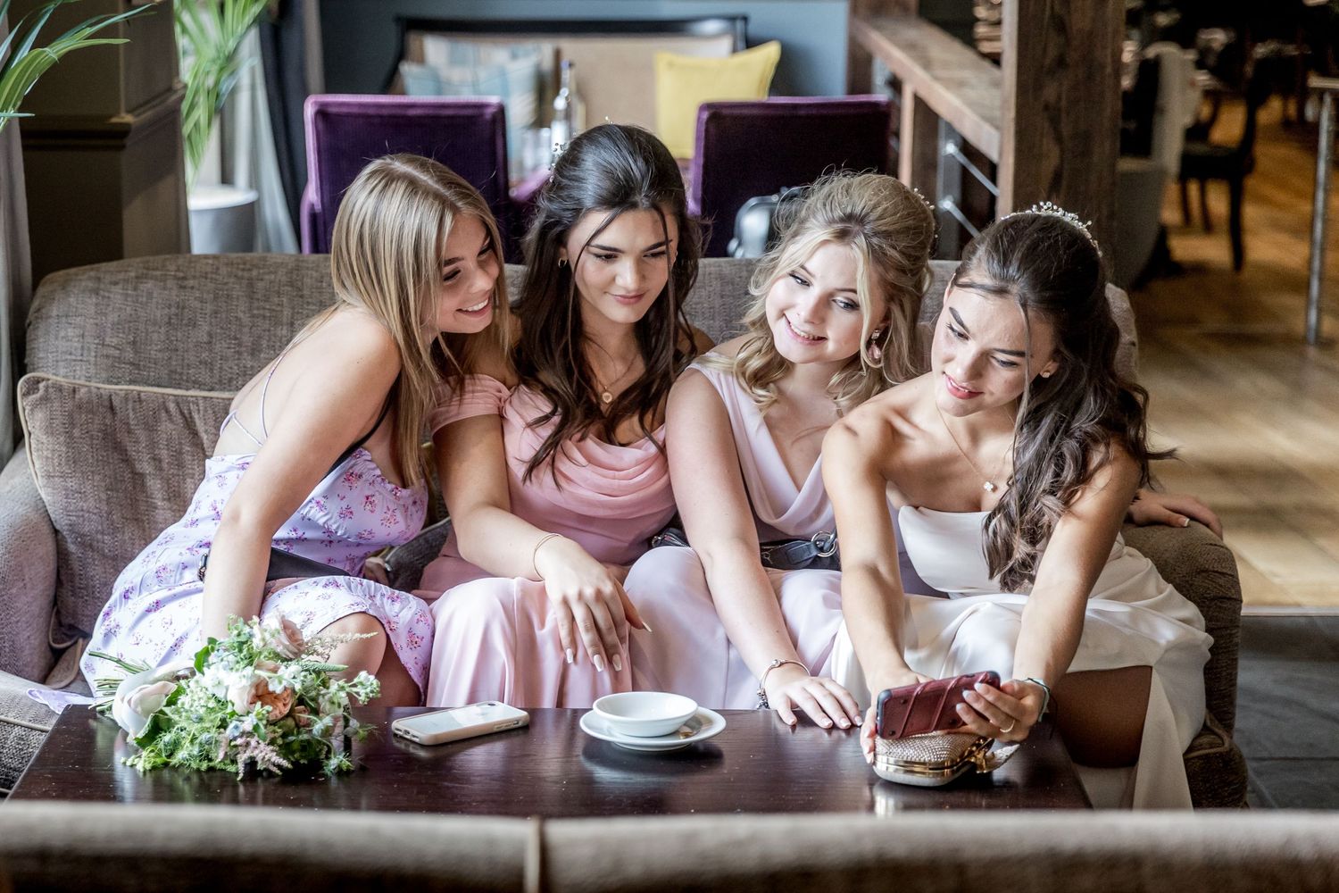 Candid moments of wedding guests gathered around tables during reception.
