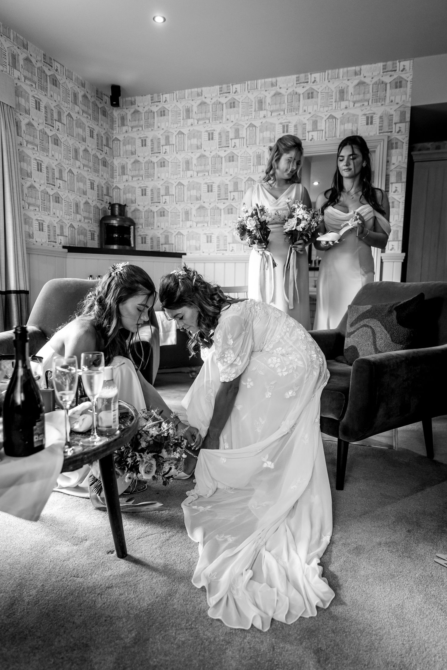 Black and white photo series showing the elegant movement of a wedding dress being put on.
