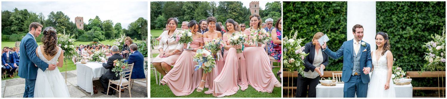 Wedding party and guests mingling in a lush garden setting.