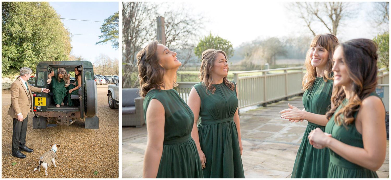 Wedding party in emerald green dresses gather outdoors near trees and buildings.