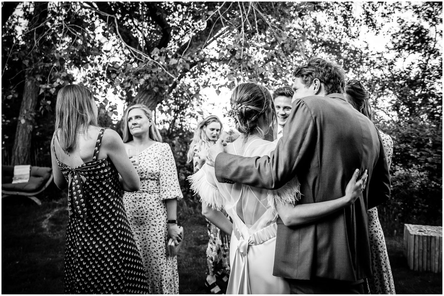 Black and white candid shots of wedding guests enjoying outdoor celebration.