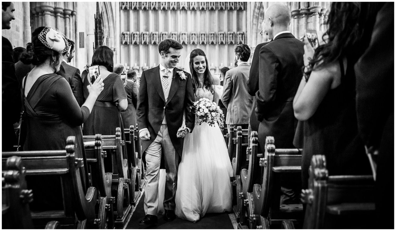 Black and white wedding photos showing intimate moments during a ceremony and reception with dancing and celebration.