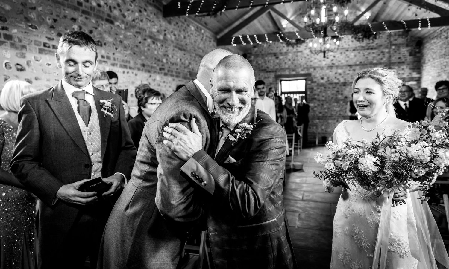 A collection of black and white wedding photographs showing candid moments and emotional reactions during a celebration.