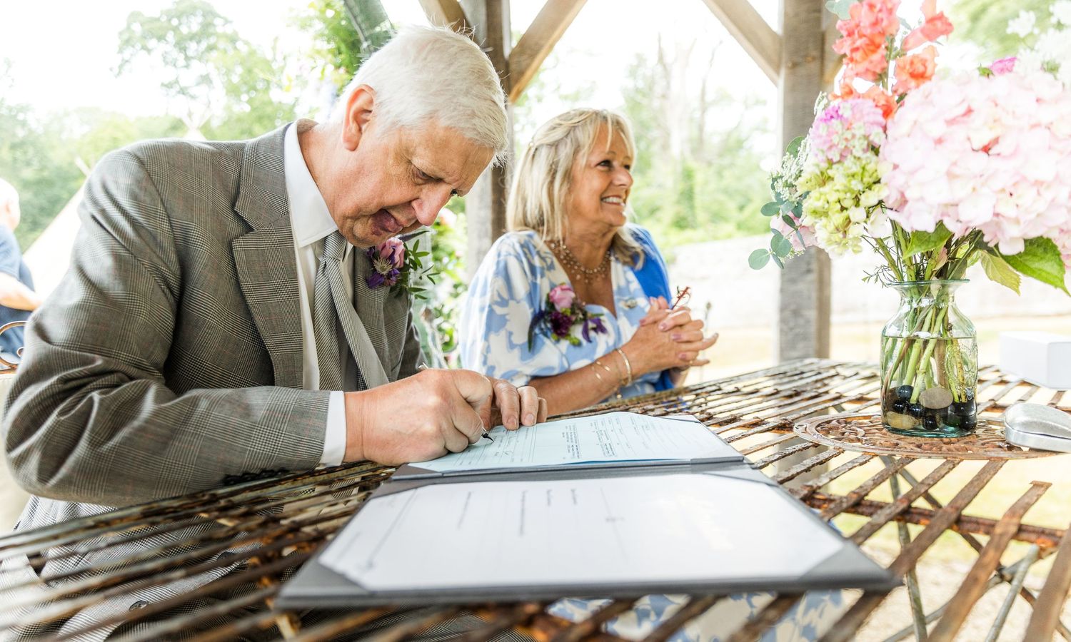 Wedding guests enjoying drinks and conversation at an outdoor reception.