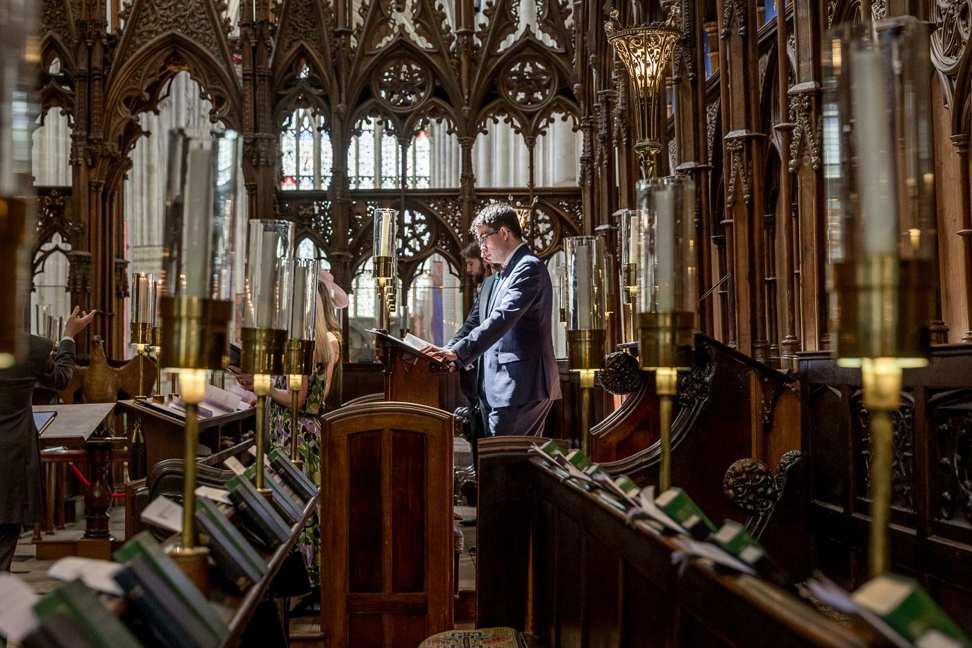Historic church interior featuring Gothic woodwork and dramatic lighting.