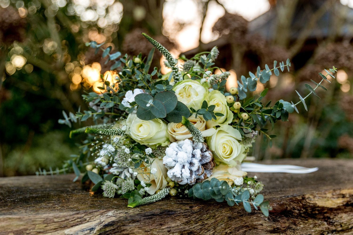 Photograph of the bride's bouquet on a bench in the gardens of Clock Barn