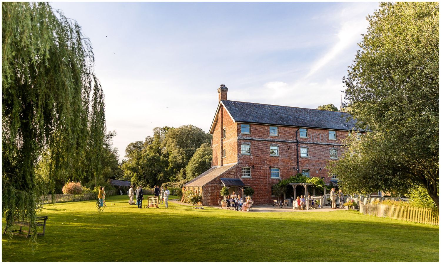 Sopley Mill wedding photograph with the building bathed in golden evening light