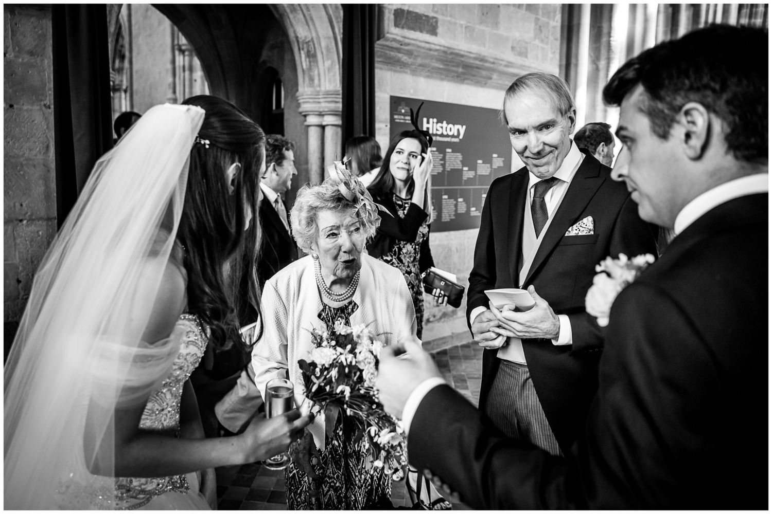 A collection of black and white wedding photographs showing candid moments during a reception celebration.