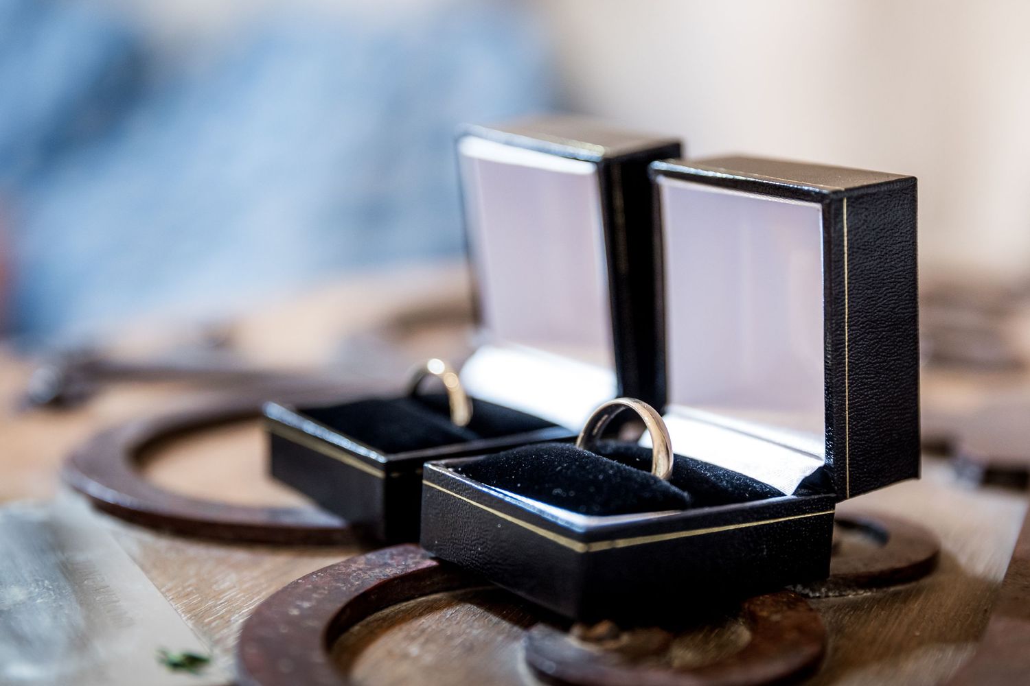 Close-up details of wedding rings displayed on a textured surface.