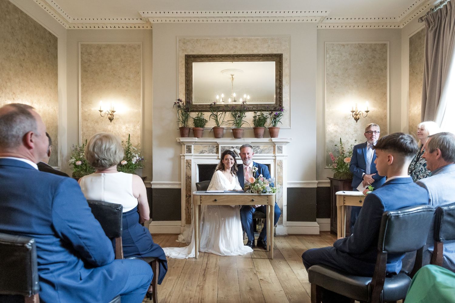 Interior of an elegant wedding venue with chandelier and classic decor.
