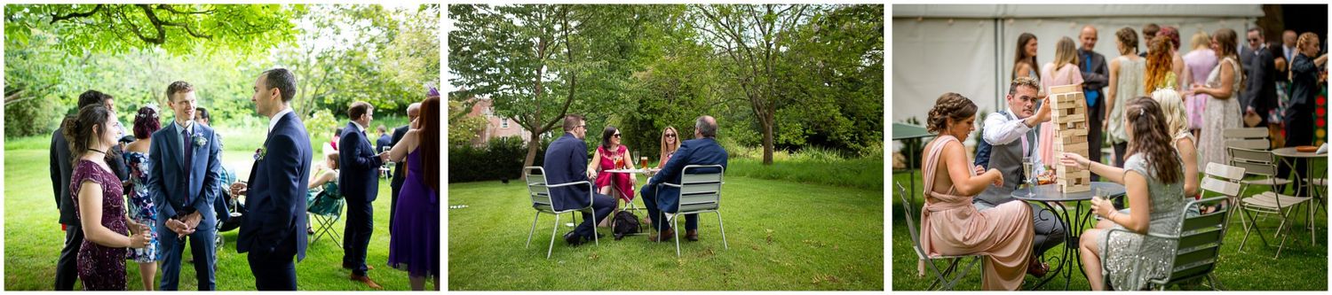A group of people enjoying an outdoor gathering in a lush green park setting.
