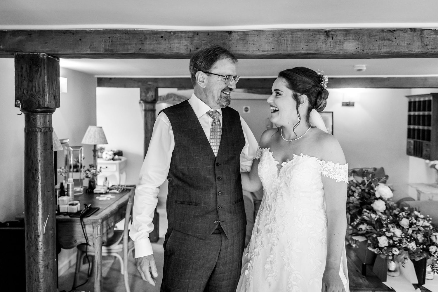 Wedding party members share emotional moments before the ceremony in a rustic venue.