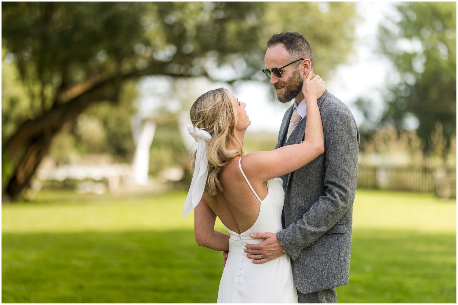 Wedding couple shares intimate first look moment in a scenic garden setting.