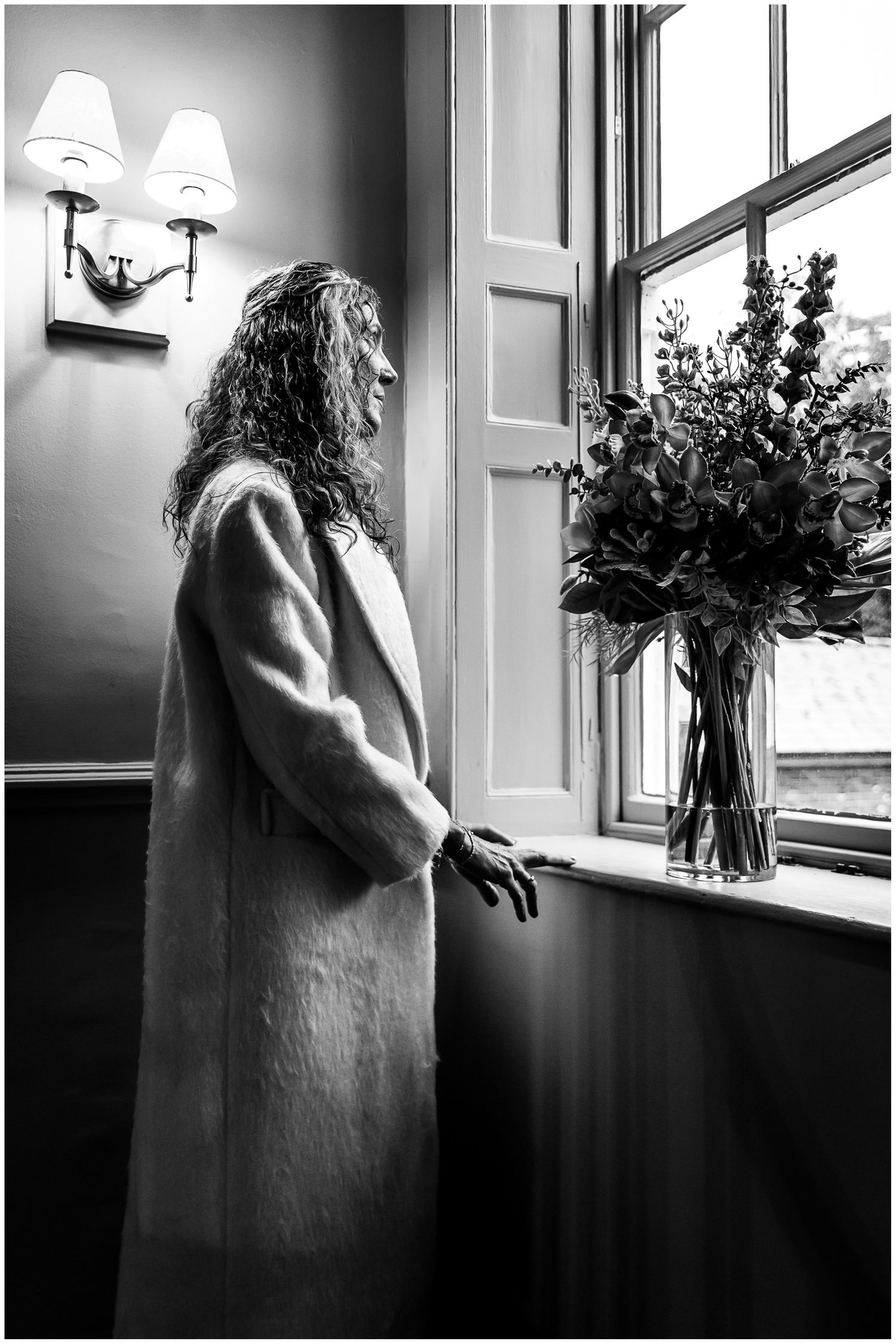 Black and white portrait of the bride looking out of the window at the Hotel du Vin in Winchester