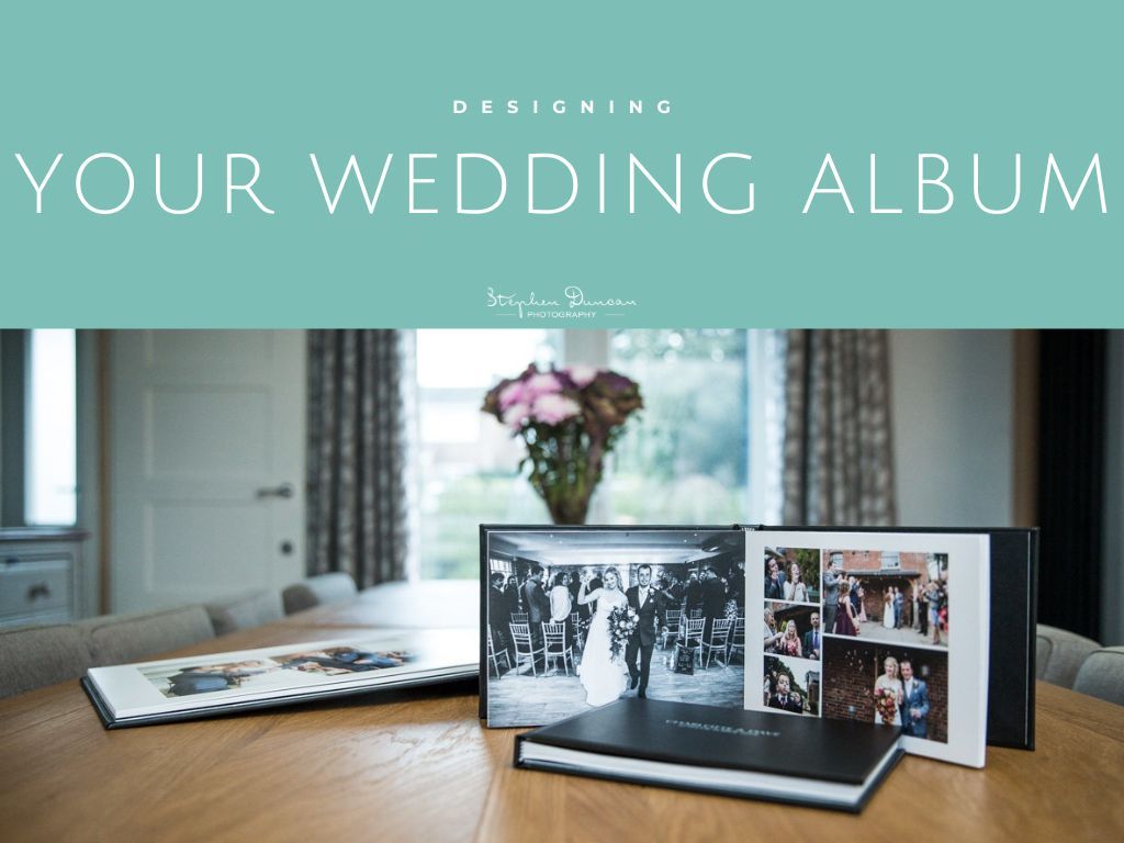 Professional wedding album samples displayed in a studio with teal wall and decorative frames.