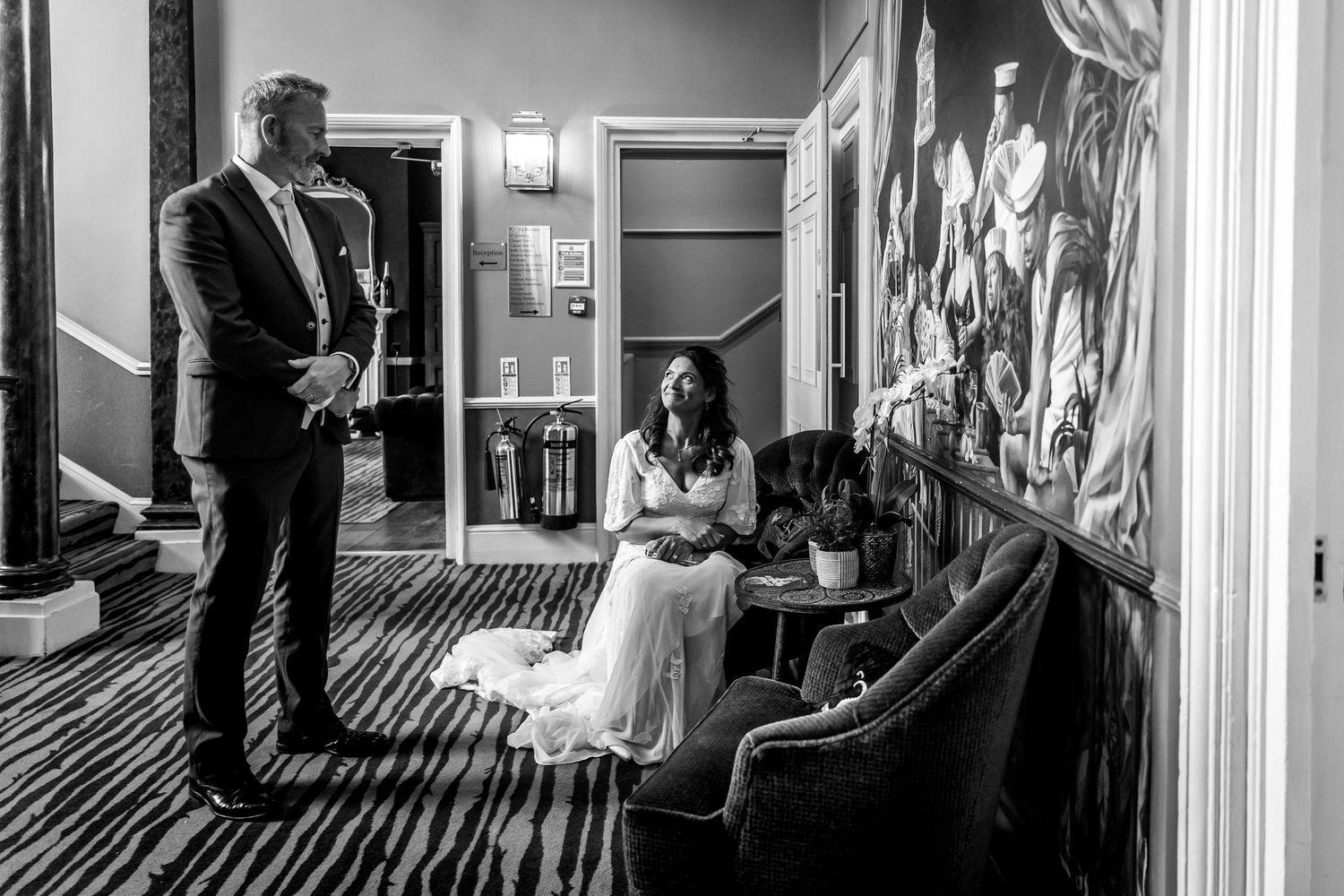Wedding reception candid moments showing guests and celebrations in black and white.