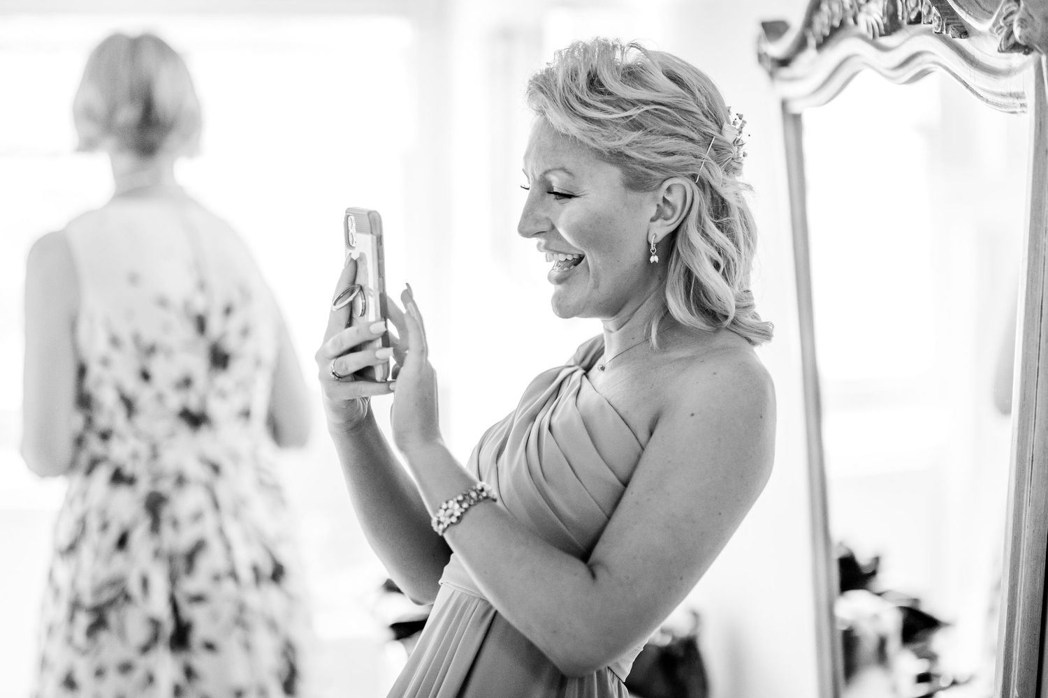 Black and white candid shots capture emotional moments during wedding preparations.