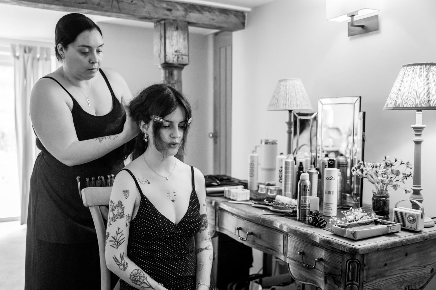 Wedding preparation scene with makeup and styling tools on table.