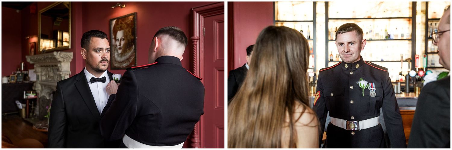 People gathered in a dimly lit bar or restaurant setting with red walls and warm lighting.