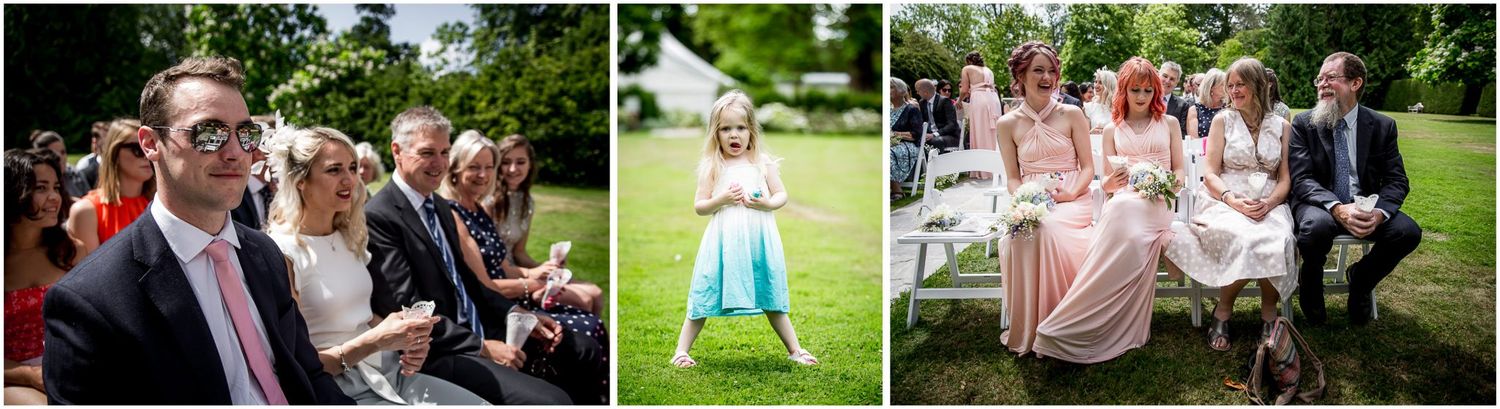 Wedding party poses for candid photos on lush green lawn during outdoor summer celebration.