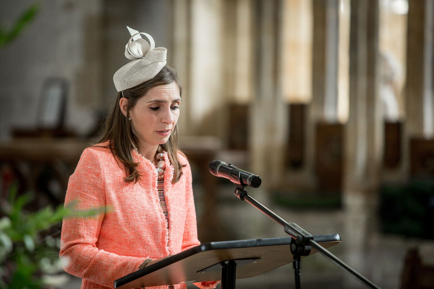 Wedding ceremony readings being delivered at an ornate church podium.