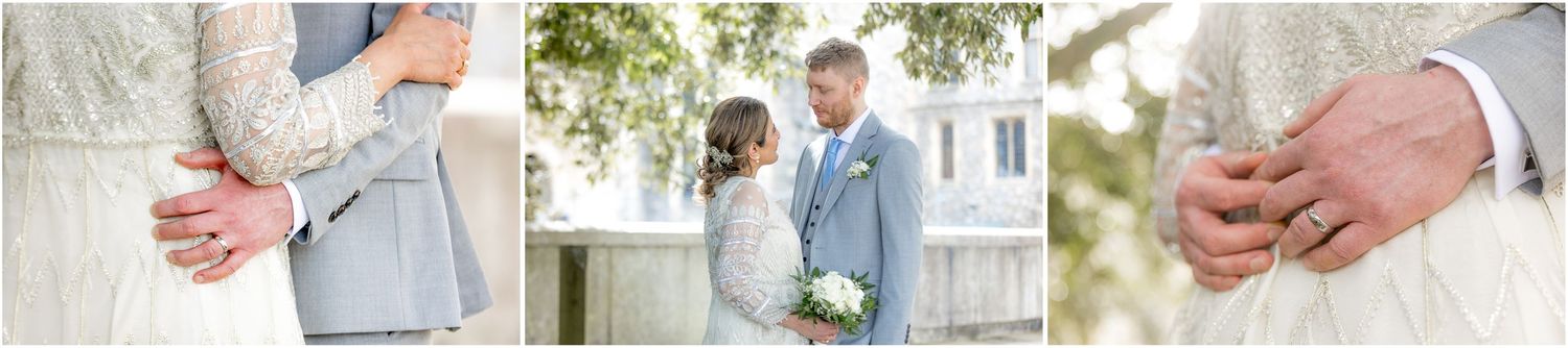 Close-up details of wedding couple holding hands outdoors.
