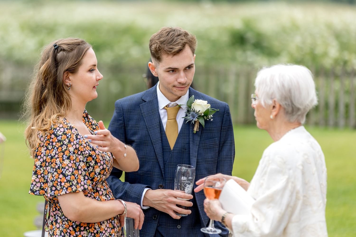 Wedding celebration candid moments captured in an outdoor garden setting.