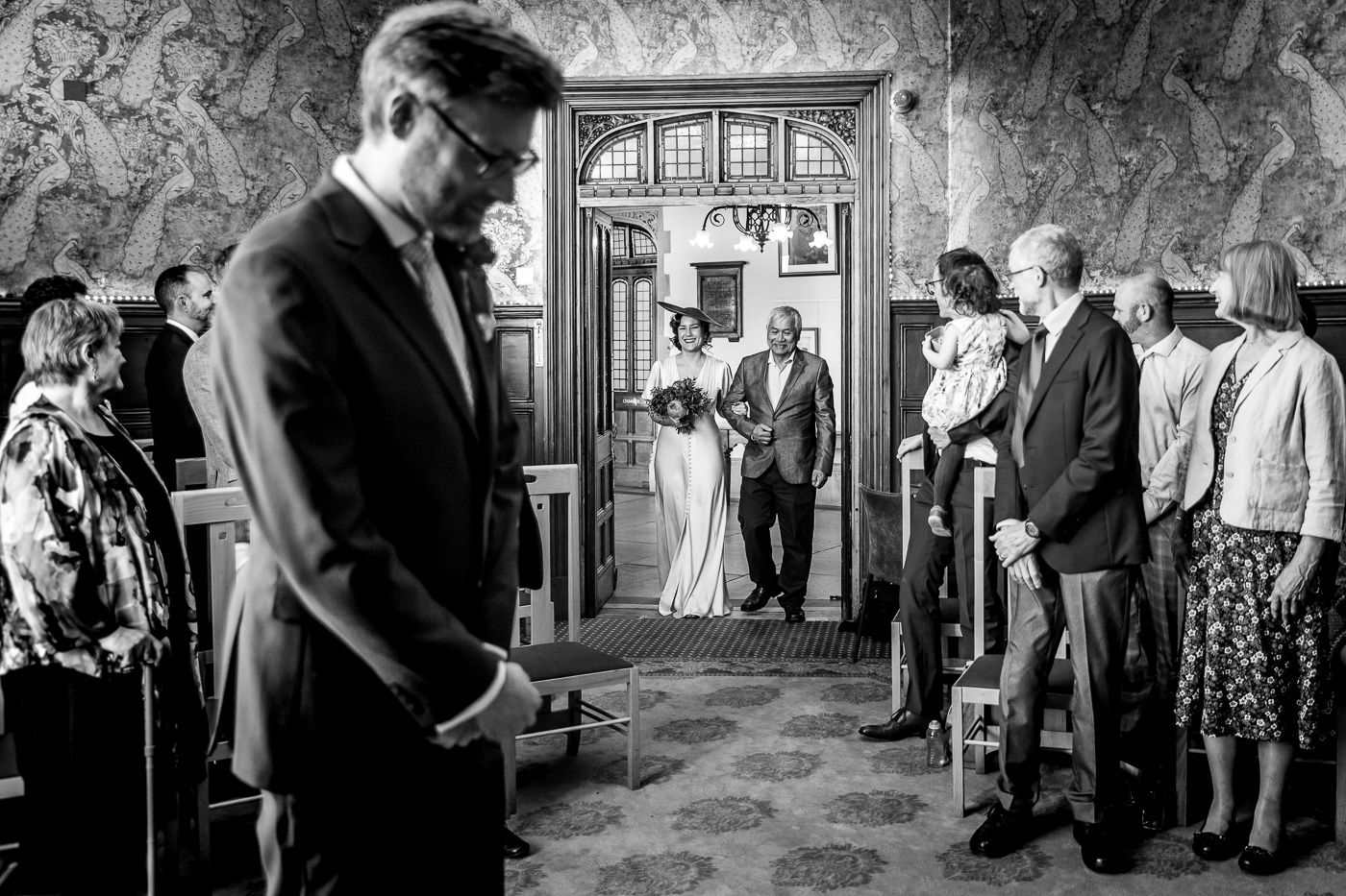 Vintage black and white photograph of guests mingling at an elegant formal event.