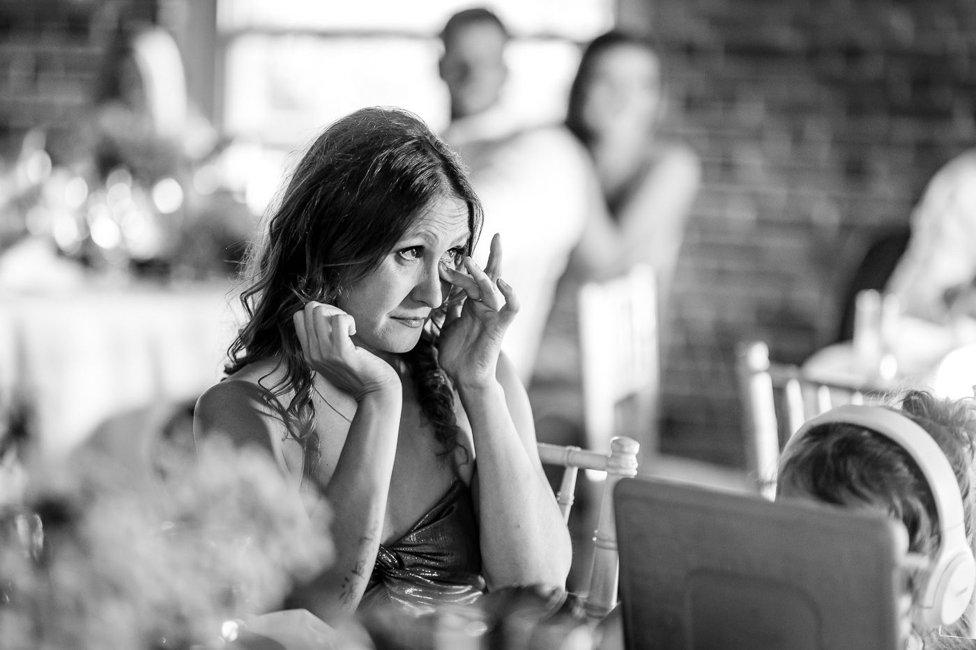 Black and white candid shots of emotional reactions during a wedding ceremony.
