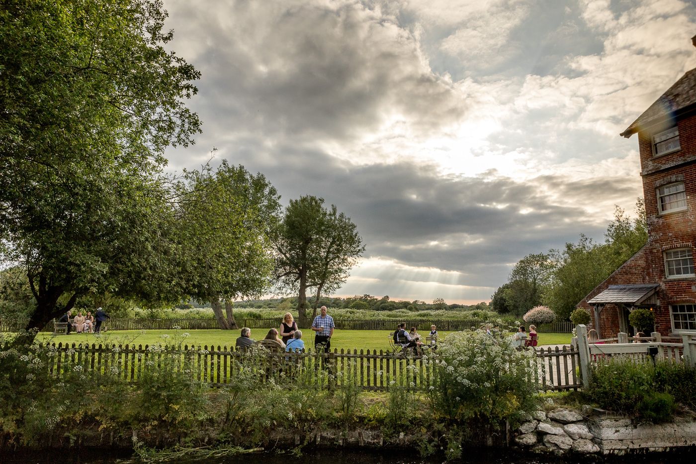 Panoramic landscape view of a countryside wedding venue with dramatic cloudy skies.
