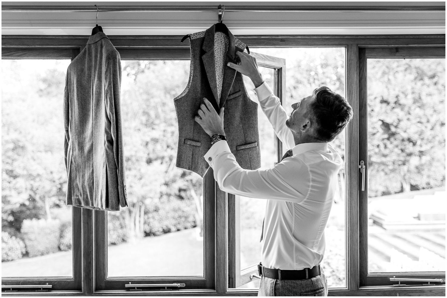 Series of black and white photos showing preparation moments near large windows.